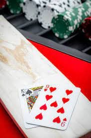 Close-up of live dealer handling cards in a studio setting